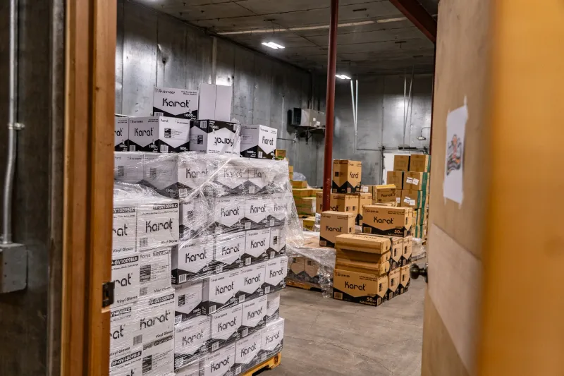 Pallets of Karat vinyl glove cases wrapped and stacked in the Yakima warehouse