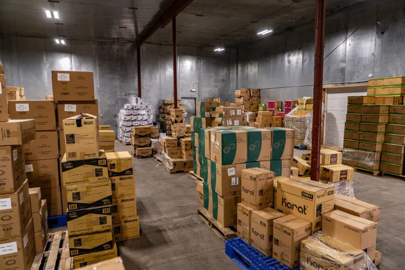 Wide view of the Yakima wholesale warehouse floor: pallets and cases staged for pickup